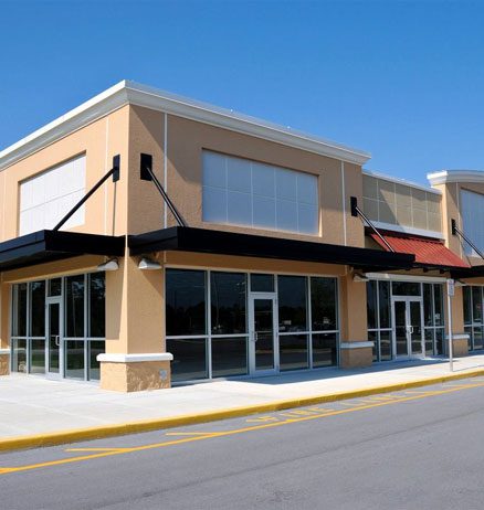 A large commercial building with a red awning.