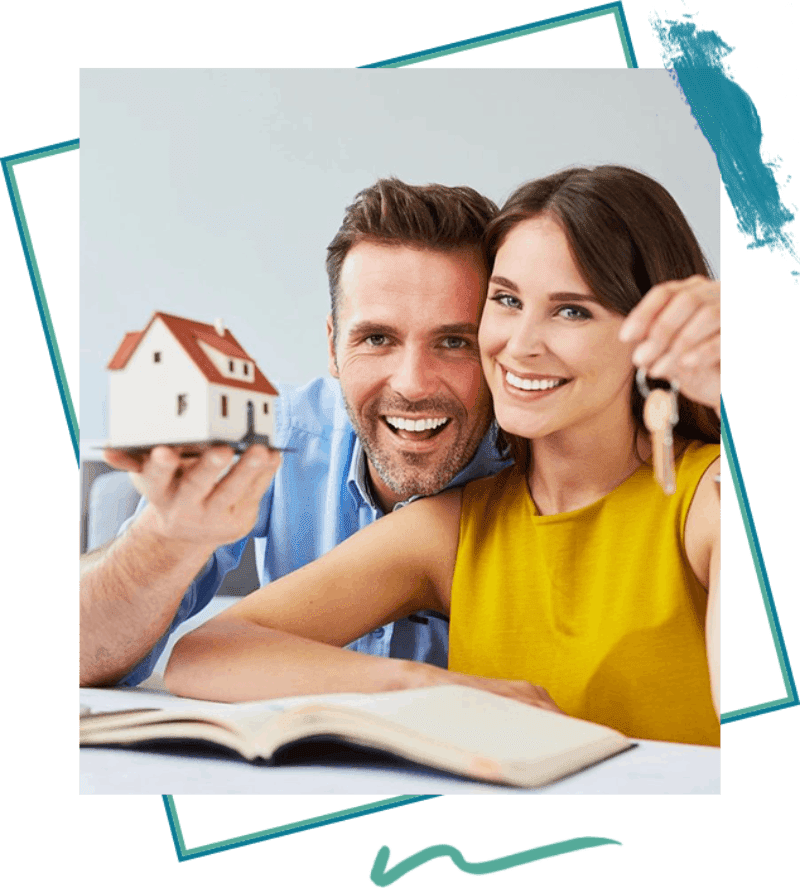 A man and woman holding keys to their new home.